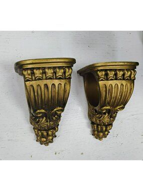 Pair Of Gold Tone Drapery Sconces With Ornate Floral Design